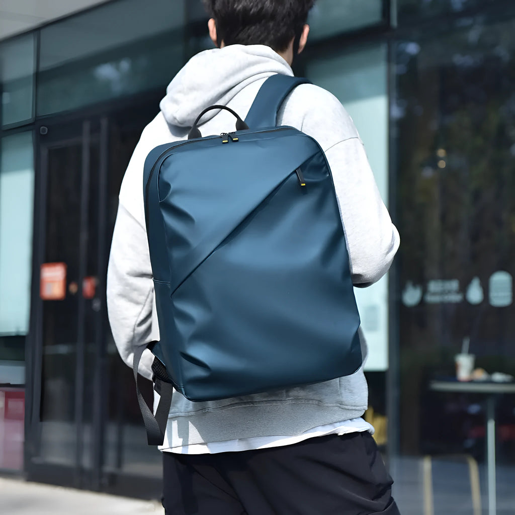 Waterproof large capacity black PU backpack with sewing thread detailing, shown closed.