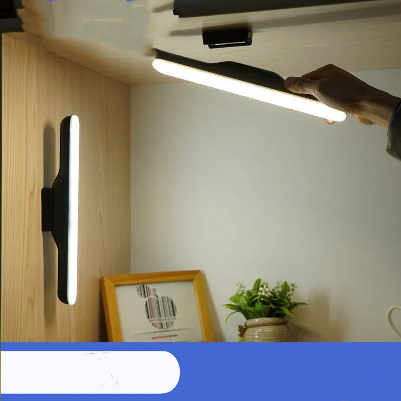 Modern white plastic rechargeable desk lamp with touch-sensitive base for dimming control on a wooden desk.