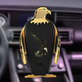 Car phone holder with wireless charging pad and Eagle design on a car dashboard.