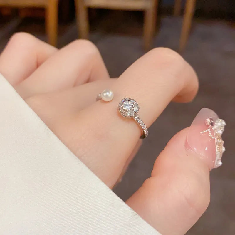 Open-end pearl ring with round zircon decoration in gold or silver colour with thick real gold plating