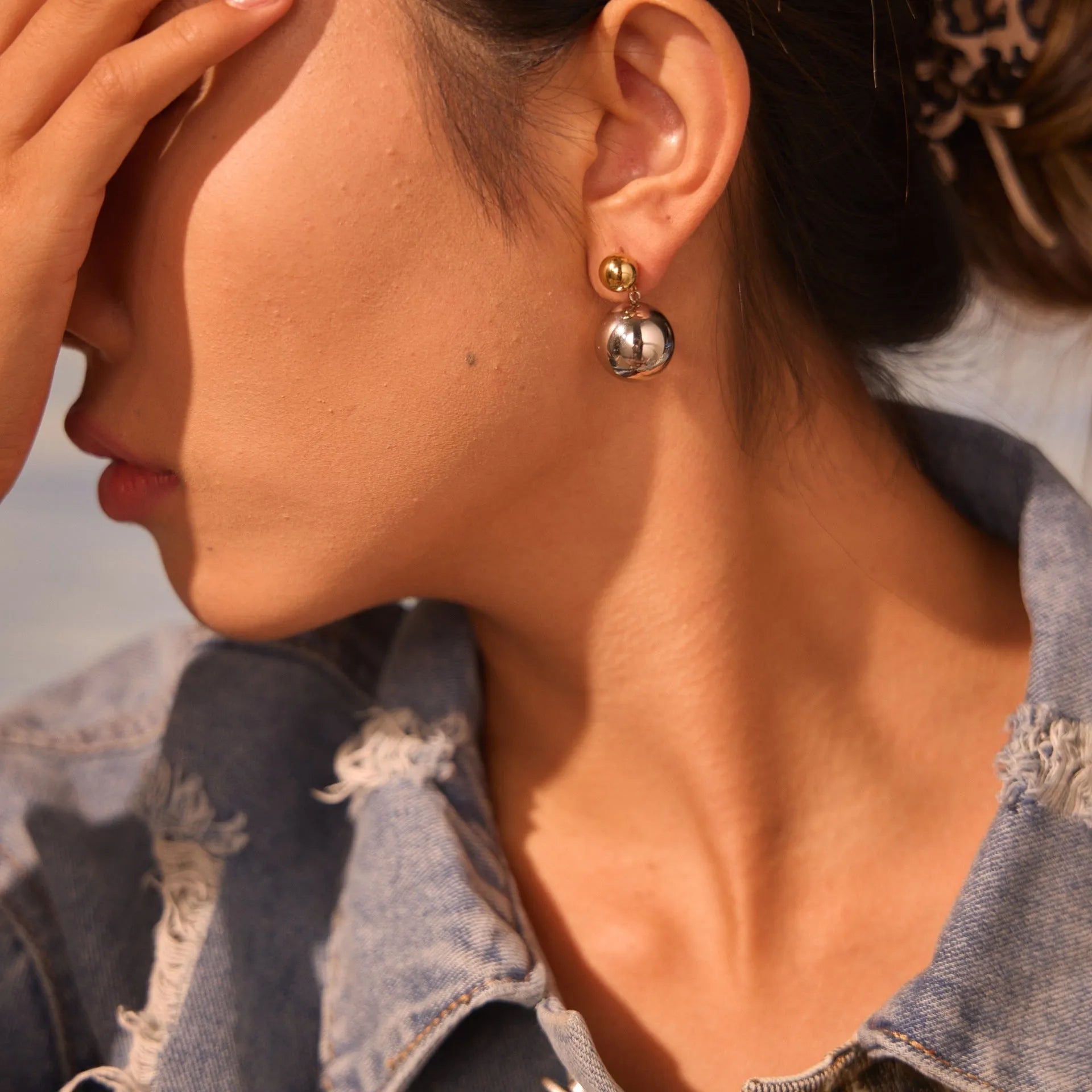 A pair of stainless steel colour-block ear studs with round beads and an 18K gold electroplated finish.