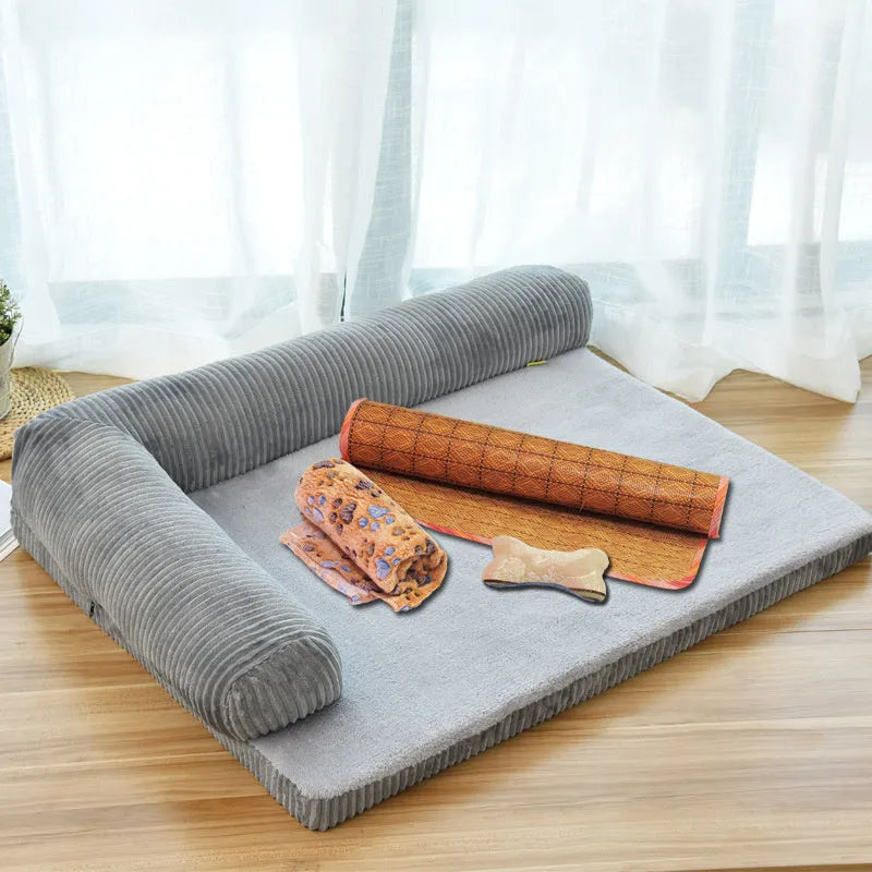 Corduroy dog sofa bed with bolster, shown in grey, placed on a wooden floor.