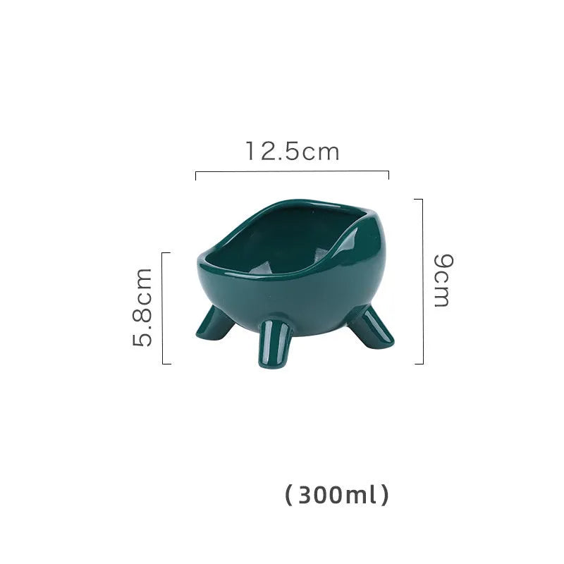 Green ceramic pet food bowl with four legs and a wide, rounded opening.