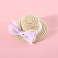 Cat wearing a woven Lafite leaves straw hat with a blue pearl butterfly bow.