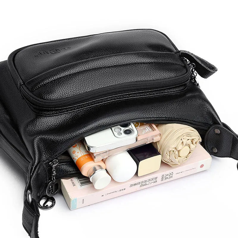 Large black women's shoulder bag with multiple internal organisation pockets and crossbody strap