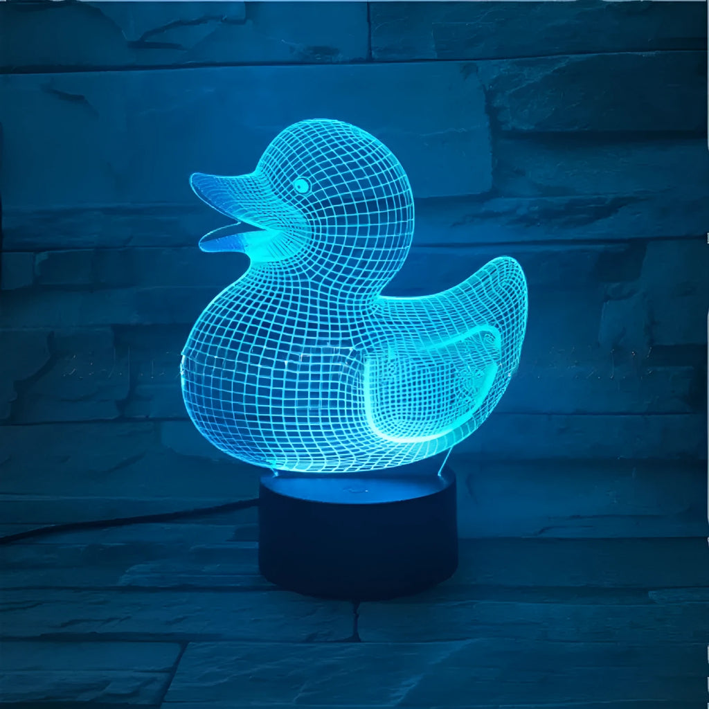 Little yellow duck 3D LED night light showing colour change modes on a desktop