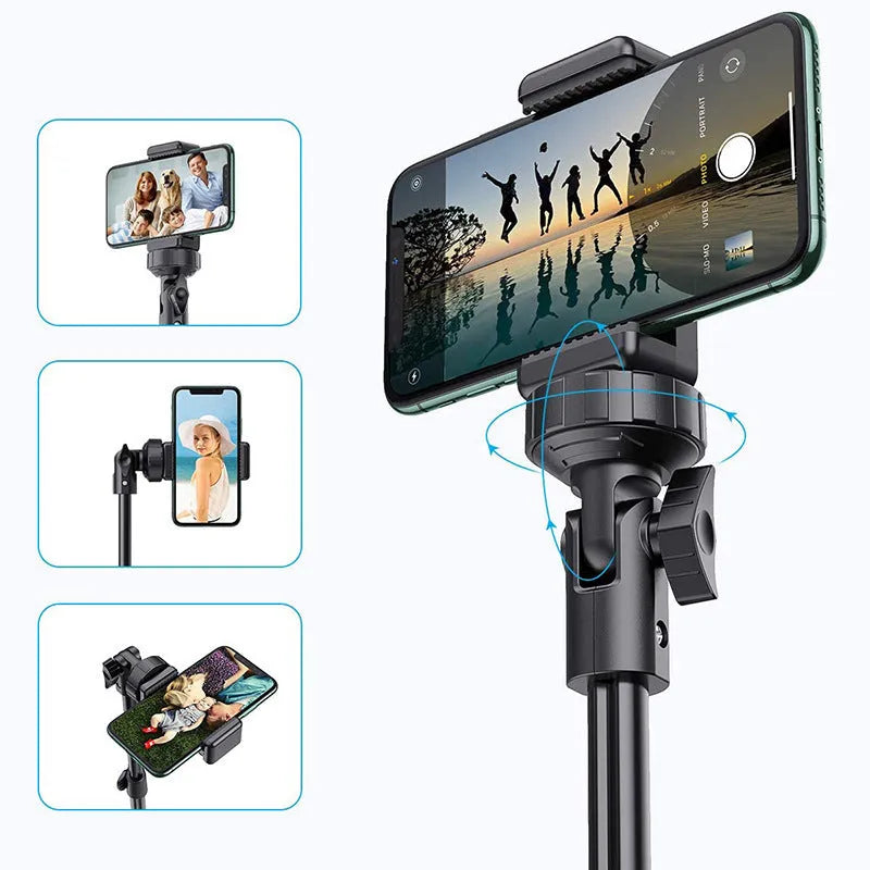 Black aluminium selfie stick tripod extended next to a smartphone, showing its 5-section telescopic shaft.