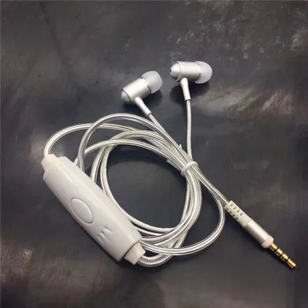 Close-up of blue LED earphones with aluminium alloy shells lit up, showing 3.5mm plug and inline remote.