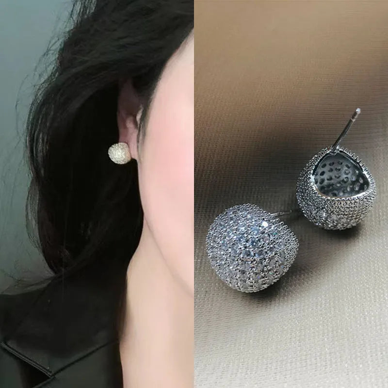 Gold and white geometric drop ear clip earrings with spherical bean design and full diamond flash