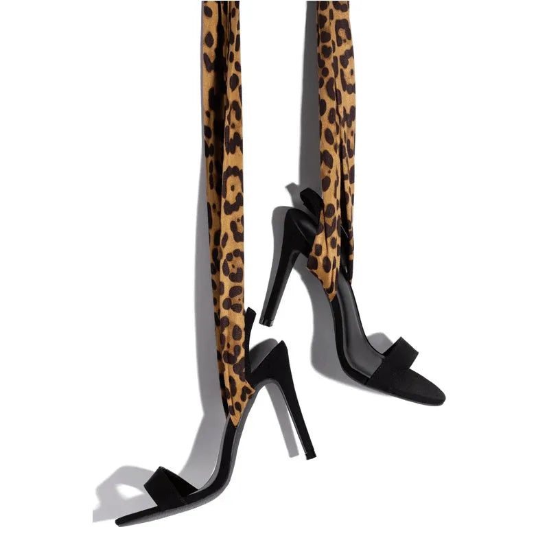 Light brown leopard print women's high-heel sandals with cross straps and a fine high heel.