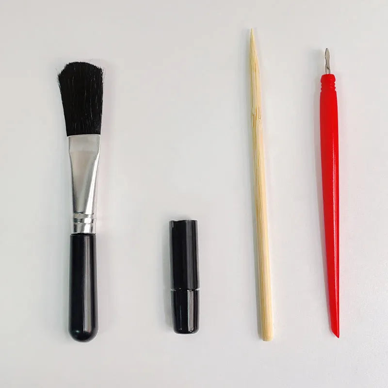 Scratch painting art tool kit containing healing pen, scratch pen, scraper, brush, and spray paint in a gift bag.