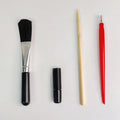 Scratch painting art tool kit containing healing pen, scratch pen, scraper, brush, and spray paint in a gift bag.