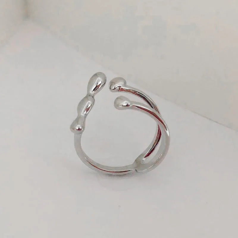 Brass adjustable fashion ring with spherical detail in gold or silver finish.