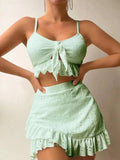 Women's solid colour three-piece bikini swimsuit with a split hip skirt.