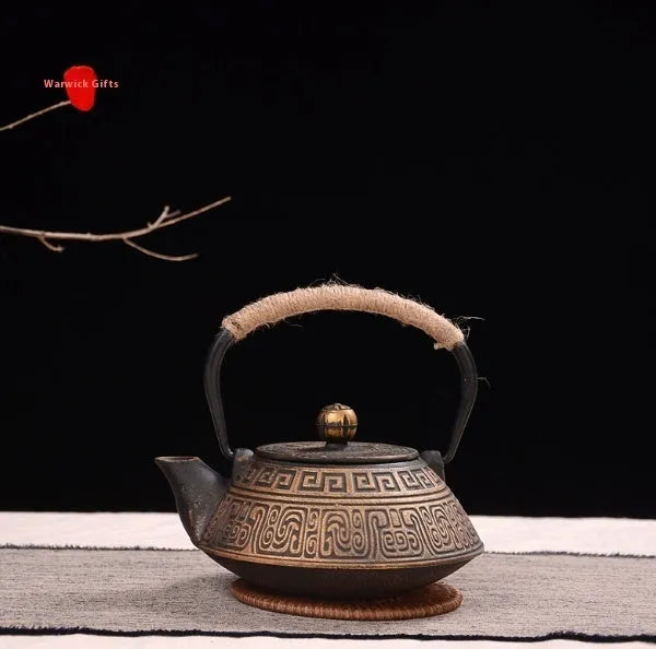Japanese-style cast iron teapot with 0.9L capacity showing decorative bronze and black patterns