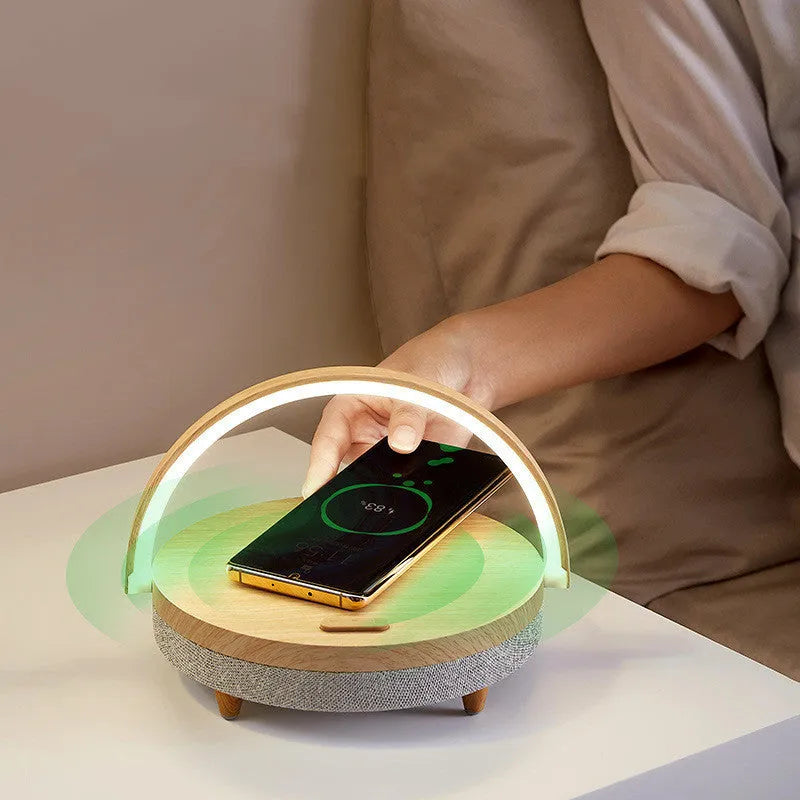 Marble pattern wireless charging night light with Bluetooth speaker and phone holder on bedside table