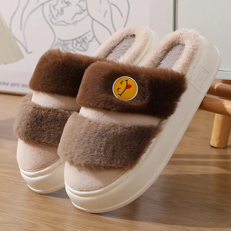 Pink and green cartoon thermal cotton slippers with plush upper and non-slip sole.
