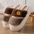 Pink and green cartoon thermal cotton slippers with plush upper and non-slip sole.