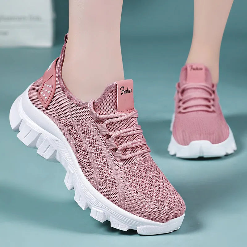 Women's white Flyknit sneakers with a thick PVC sole and lace-up front.