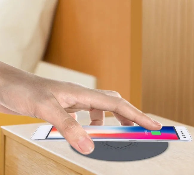 Round embedded wireless phone charger for installation in desks and furniture, shown with USB port.