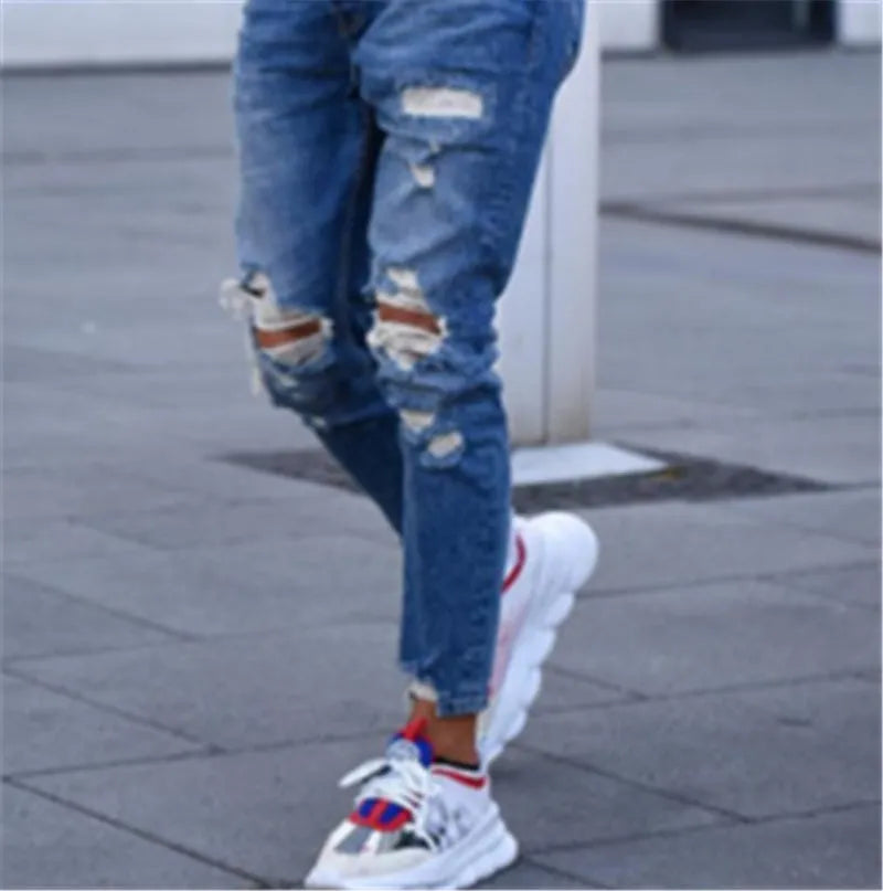 Deep blue hole jeans for men made from 100% cotton fabric showing classic denim styling