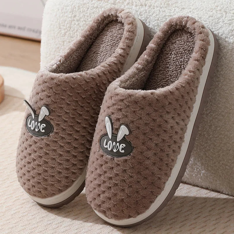 Women's rabbit plaid design artificial fur house slippers with a thick rubber sole.