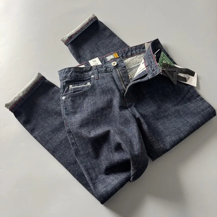 Men's straight leg denim trousers in a primary colour, showing the mid waist fit and long leg.