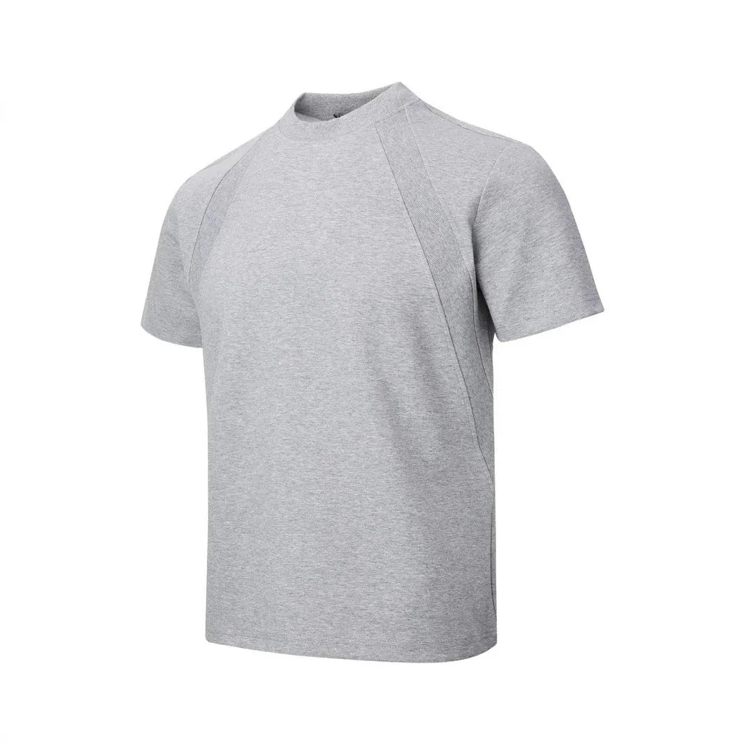 Man wearing a loose-fit black short-sleeve polyester top with air layer stitching.