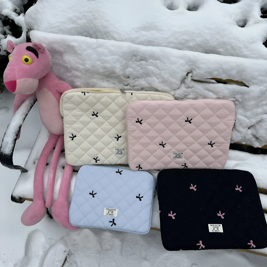 Nylon laptop storage bag with rhombus embroidery and bow in light blue, showing front detail