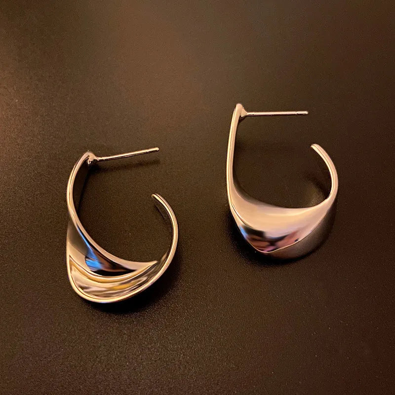 Pair of twisted geometric design metal earrings in gold or silver electroplated finish