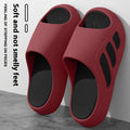 Pair of EVA platform slippers in a two-tone colour scheme, showing flip-flop style with letter detailing.