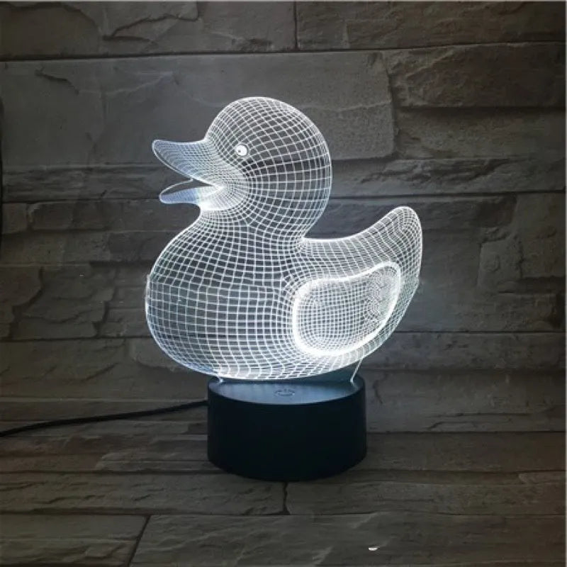 Little yellow duck 3D LED night light showing colour change modes on a desktop