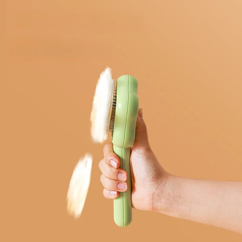 Green pet grooming comb with stainless steel needles and self-cleaning mechanism