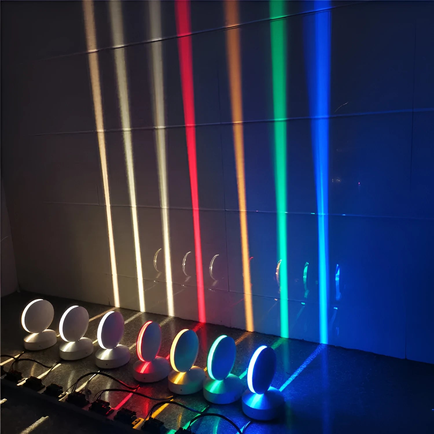 Modern aluminium and glass LED spotlight bar wall lamp mounted on a wall.