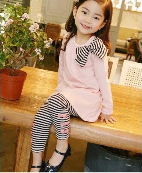 Pink cotton two-piece clothing set for a young girl, showing top and bottom.