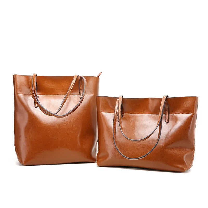 Genuine cowhide leather cross-body handbag showing two compartments and available in five colours