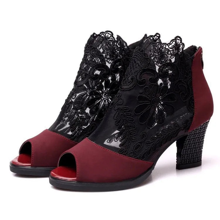 Black gladiator sandals with lace upper, square high heel, and zip closure on ankle