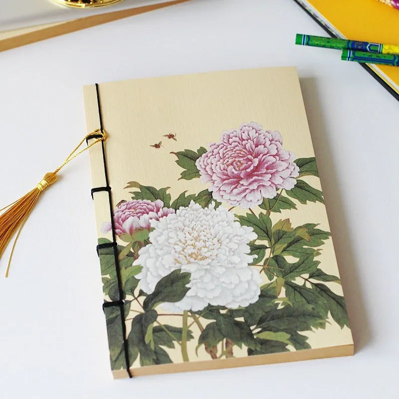 A5 antique wire-bound notebook with retro painting cover, thread binding, and black tassels.