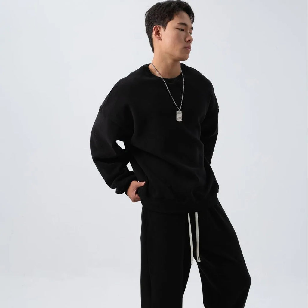 Men's black polar fleece sports suit with padded crew-neck coat and matching trousers