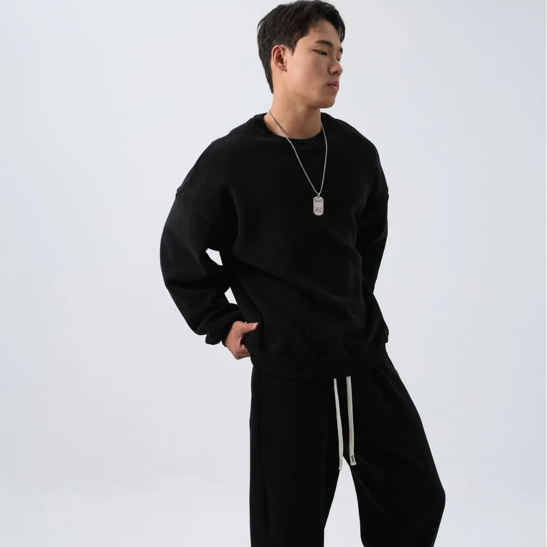Men's black polar fleece sports suit with padded crew-neck coat and matching trousers