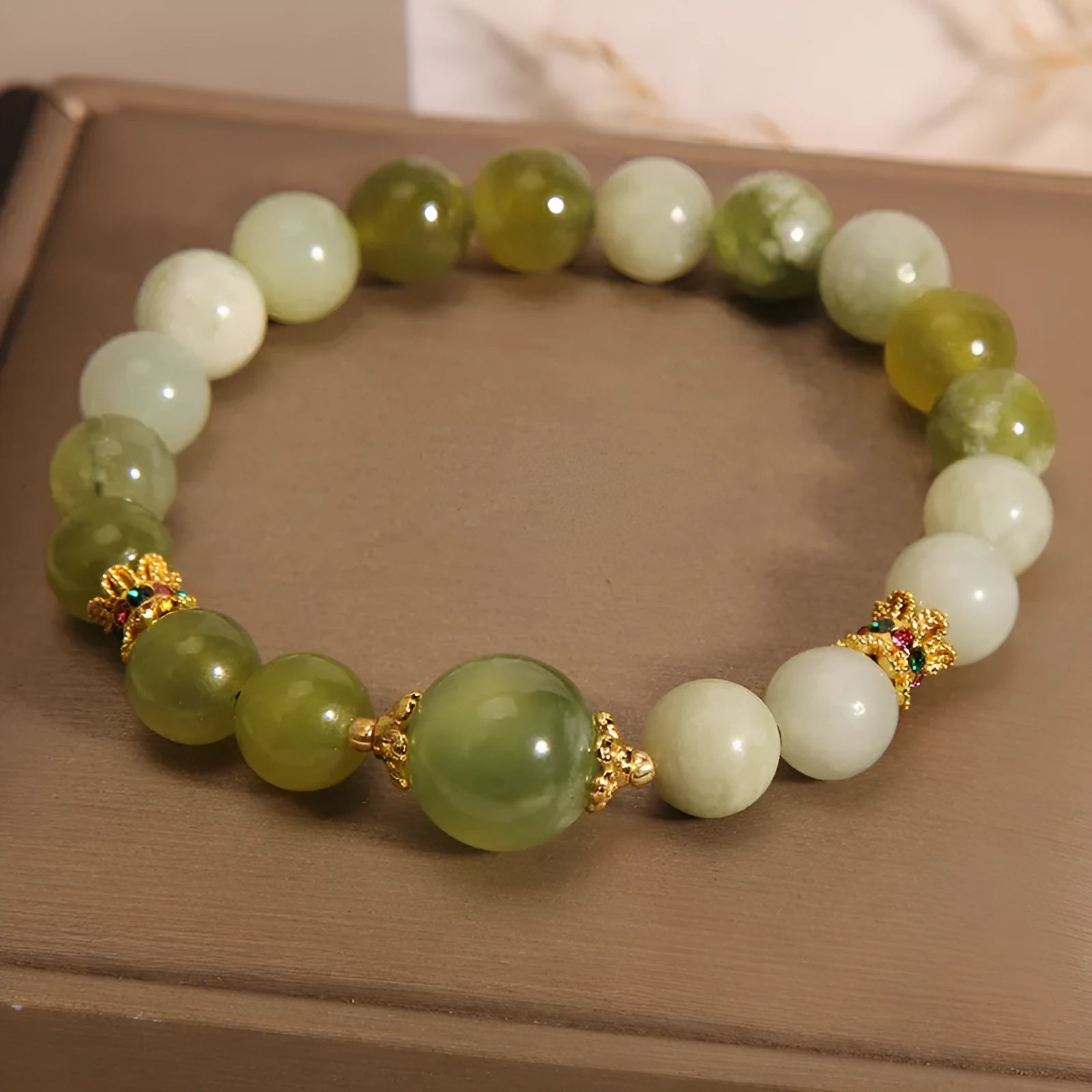 Women's bracelet made of natural green Xiuyan jade in a sweet Mori style.