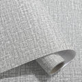 Roll of self-adhesive linen-effect wallpaper in a beige colour for wall renovation.