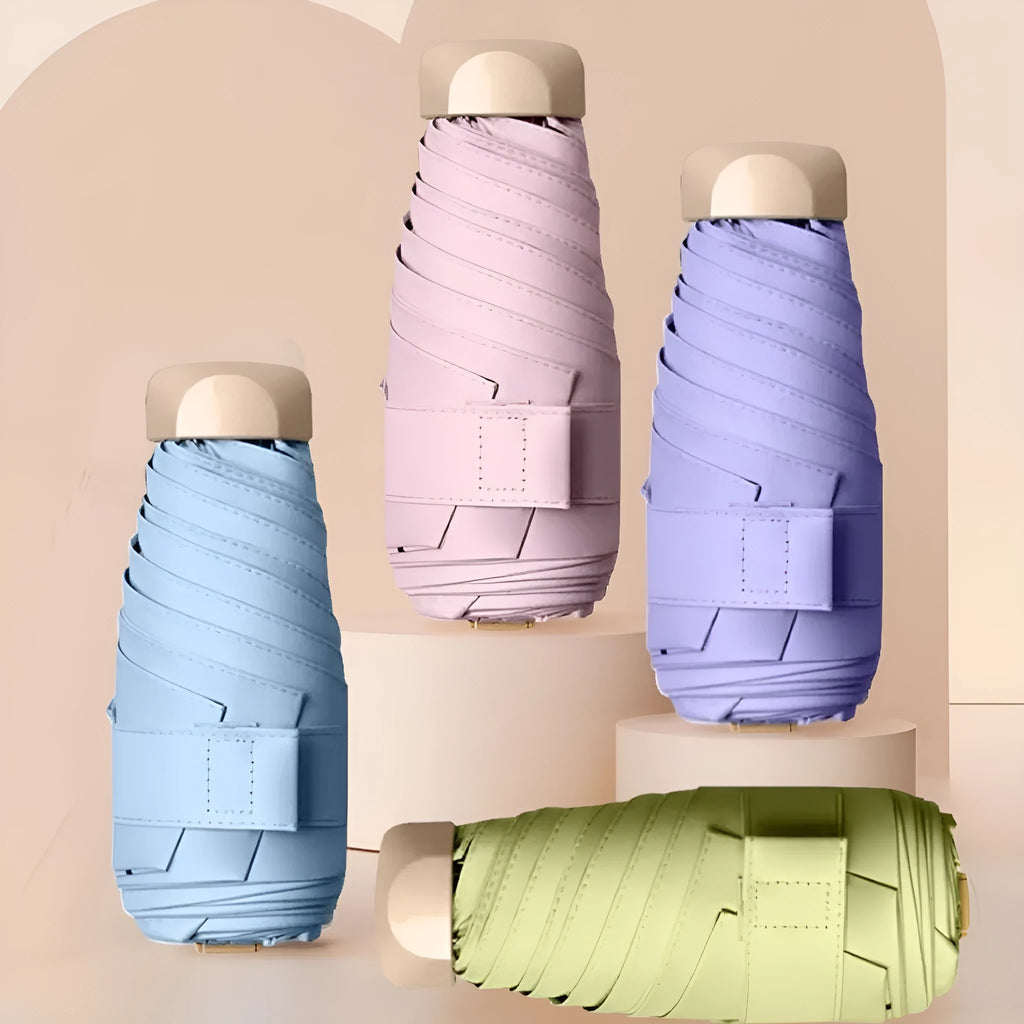 Closed five-fold gradient vinyl sun umbrella showing compact size and one of eight available colours.