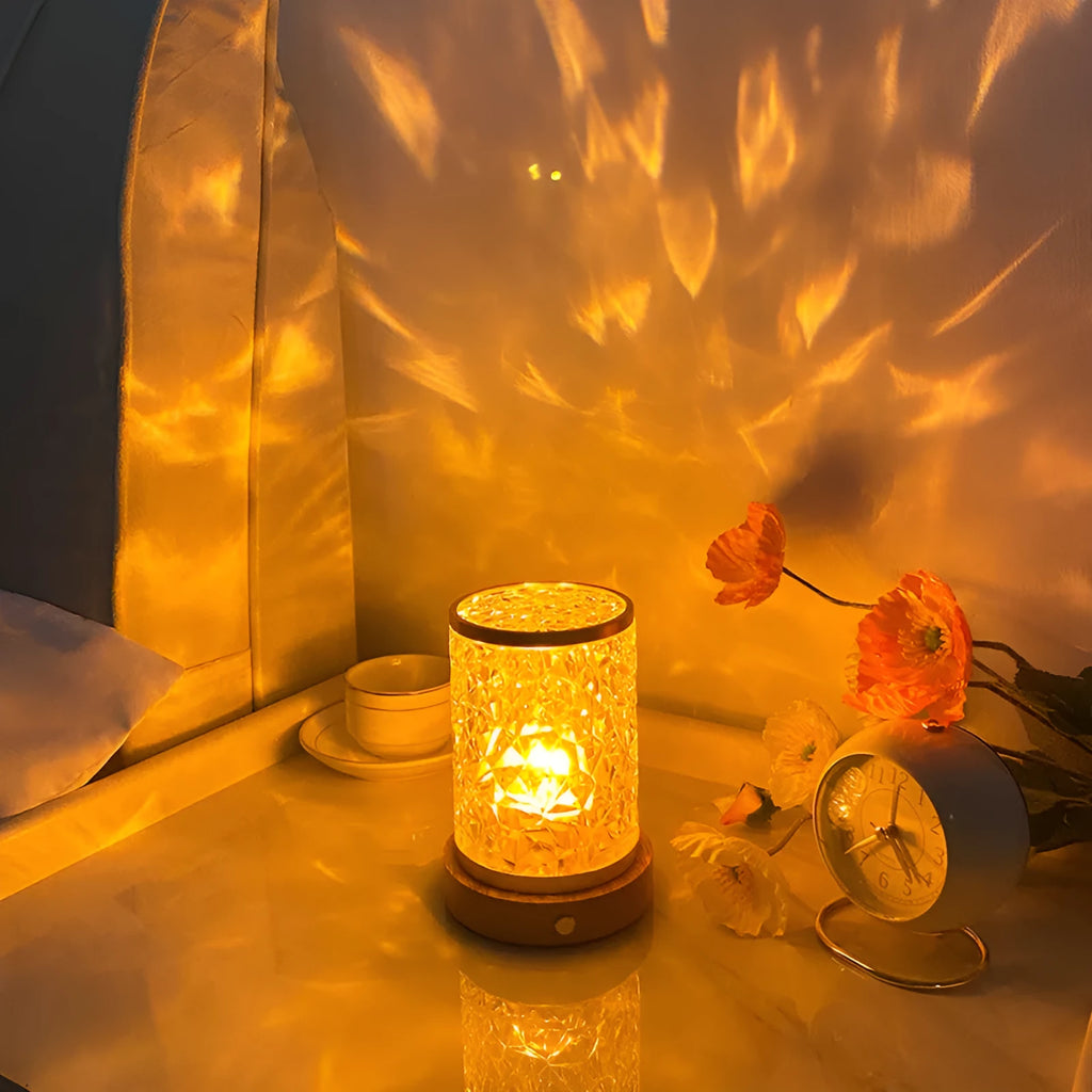 Small rotating water ripple effect night light with a solid wood base on a table