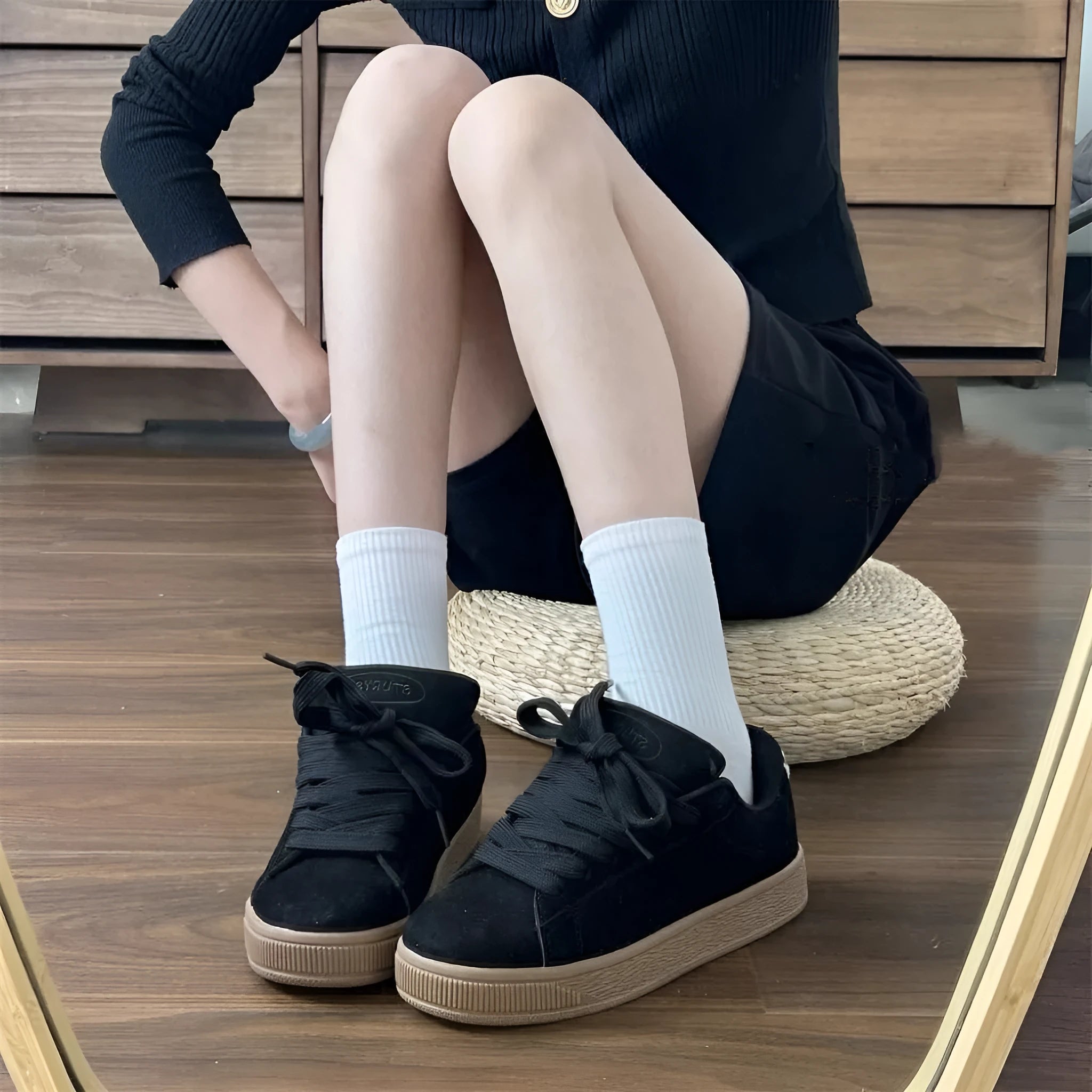 Black retro low-top sneakers with round toe design and waterproof platform construction