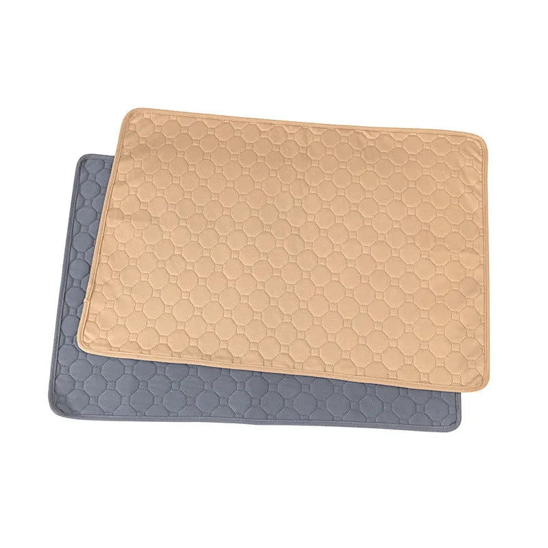 Grey and khaki washable waterproof dog pee pads on a wooden floor.