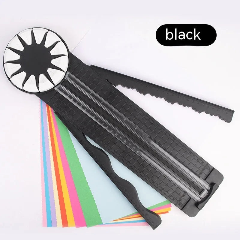 Pink plastic 12-in-1 paper cutting machine with dotted perforation wheel on craft table