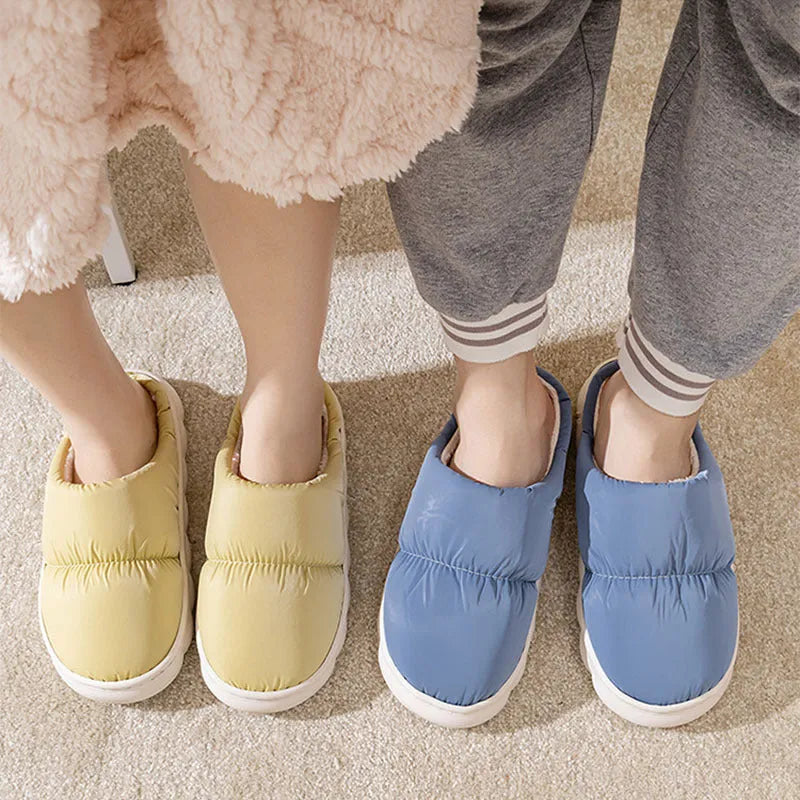 A pair of down cotton slippers with an artificial leather upper and thick rubber sole, shown in blue.