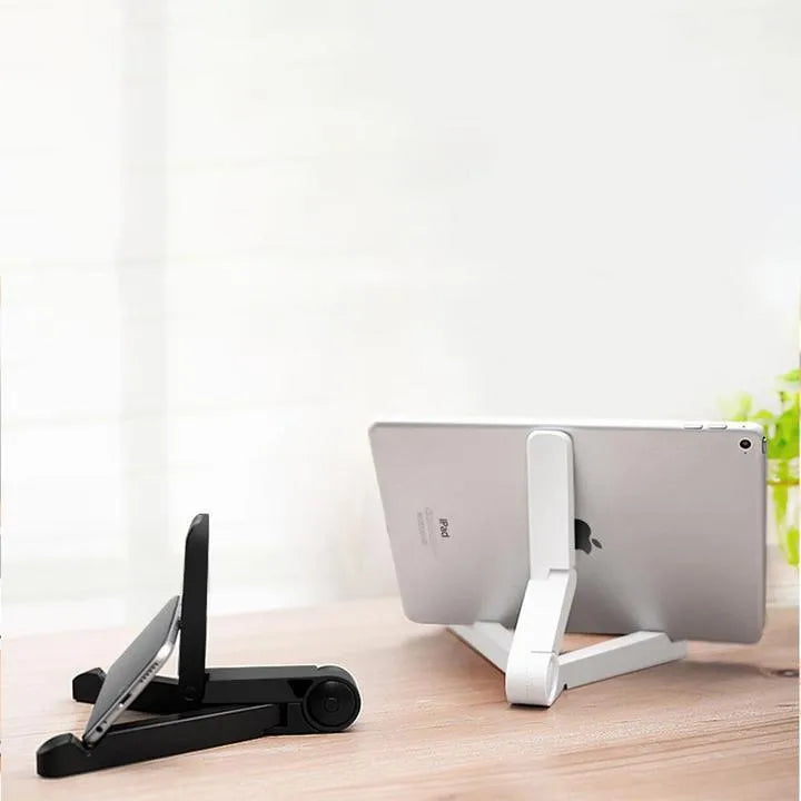 Black foldable tablet holder open in landscape mode holding a smartphone, showing its adjustable angle and non-slip base.