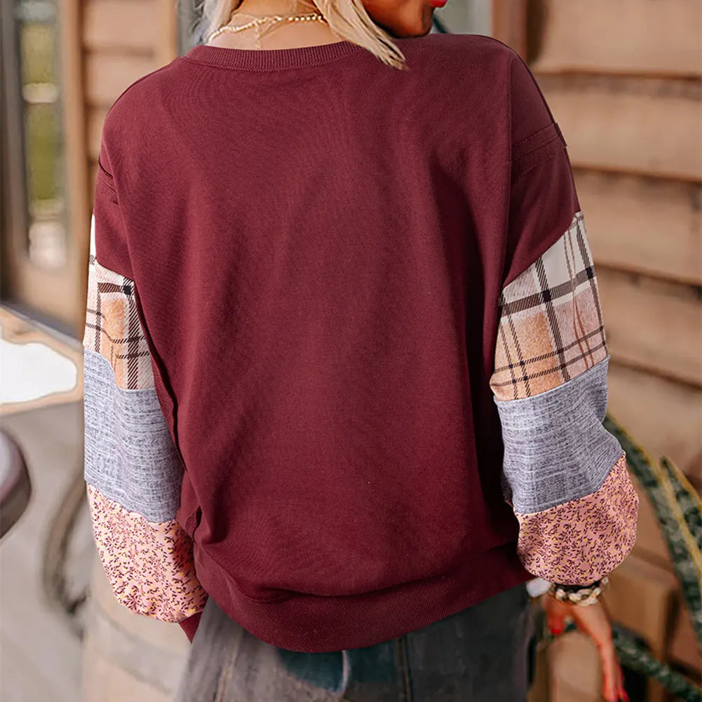 Women's beige and red plaid long-sleeved loose-fit polyester top on a hanger.